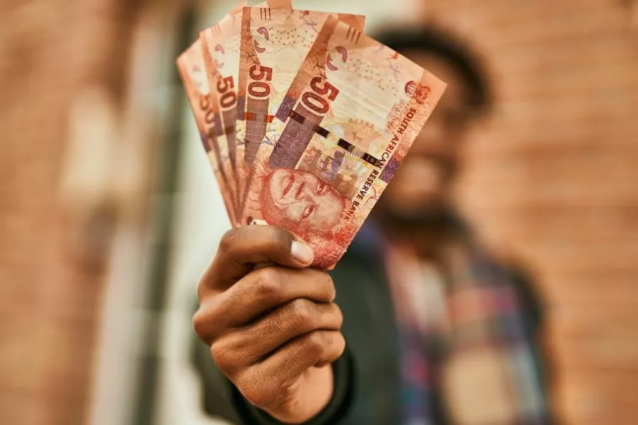 Hand holding rand notes